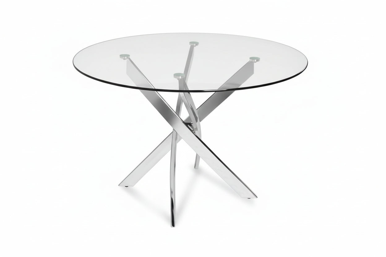 Round glass dining table with chrome cross-leg base from Meuble Divino, showcasing a sleek and modern dining room setup.