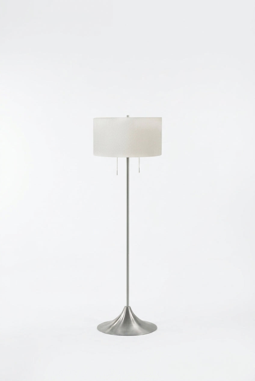 Meuble Divino Harper drum shade floor lamp with beige fabric drum shade and sleek metal base, standing on a hardwood floor.