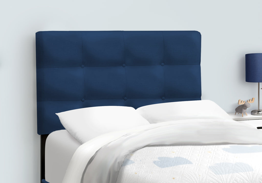 Navy blue velvet single bed by Meuble Divino with a sleek modern frame and plush upholstery, shown in a well-lit bedroom setting.