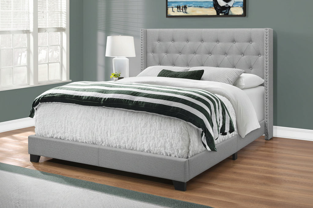 Grey wingback tufted queen bed frame with nailhead trim by Meuble Divino, showcasing plush upholstery and elegant design.