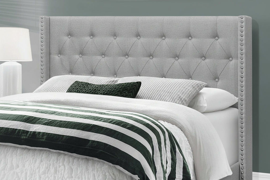 Grey wingback tufted queen bed frame with nailhead trim, featuring elegant upholstery and classic design by Meuble Divino.